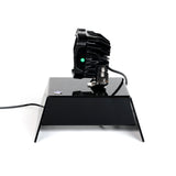 Vivid Lumen Industries tabletop display showcasing FNG 5 Hyperspot in a dark room, projecting a focused beam of light