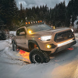 Off-road vehicle equipped with Vivid Lumen wired series light bar in amber color, illuminating the trail